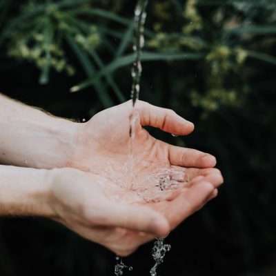 water drops on persons hand